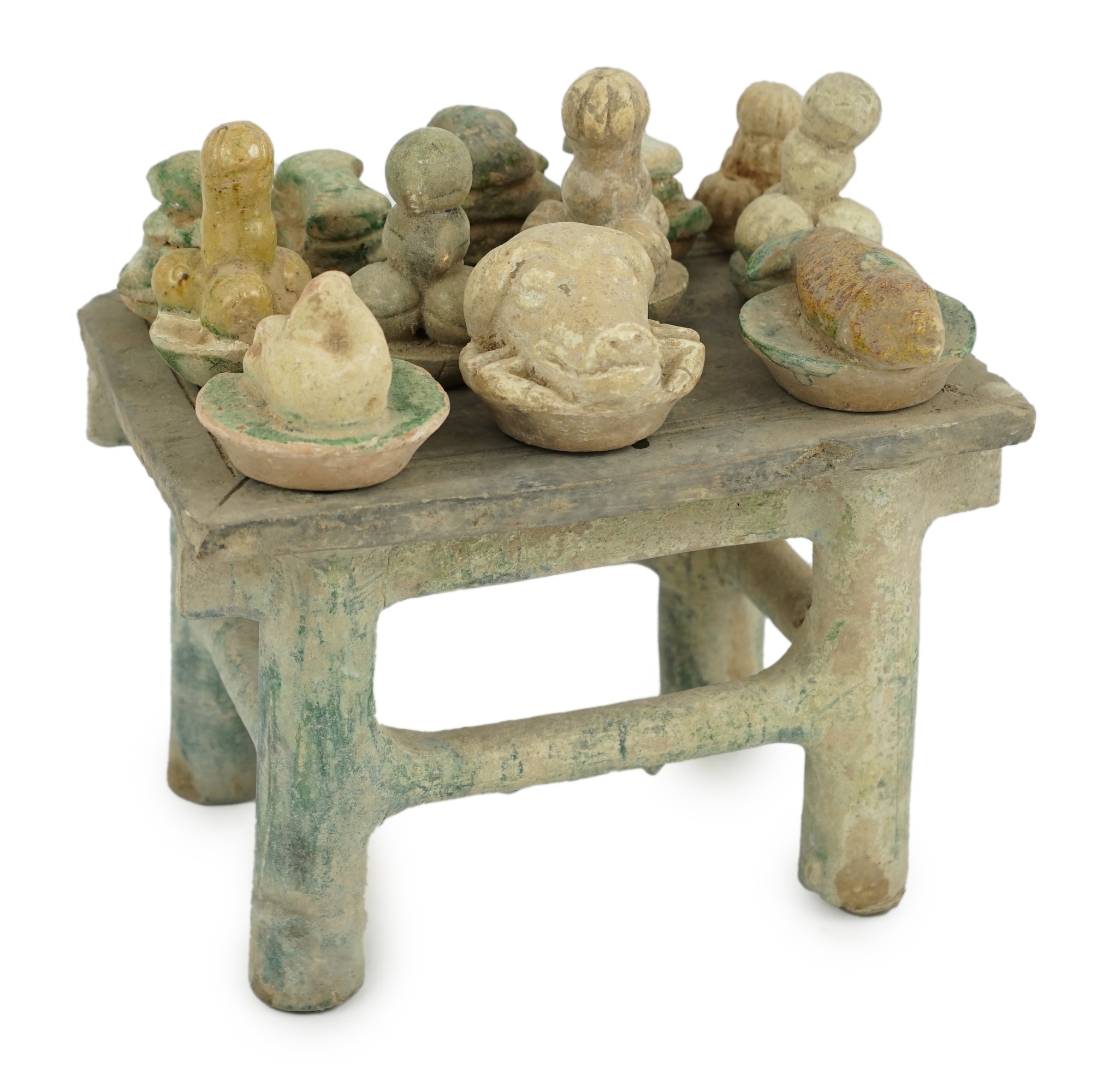 A Chinese glazed pottery altar table with food offerings, Ming Dynasty, c.1550-1600